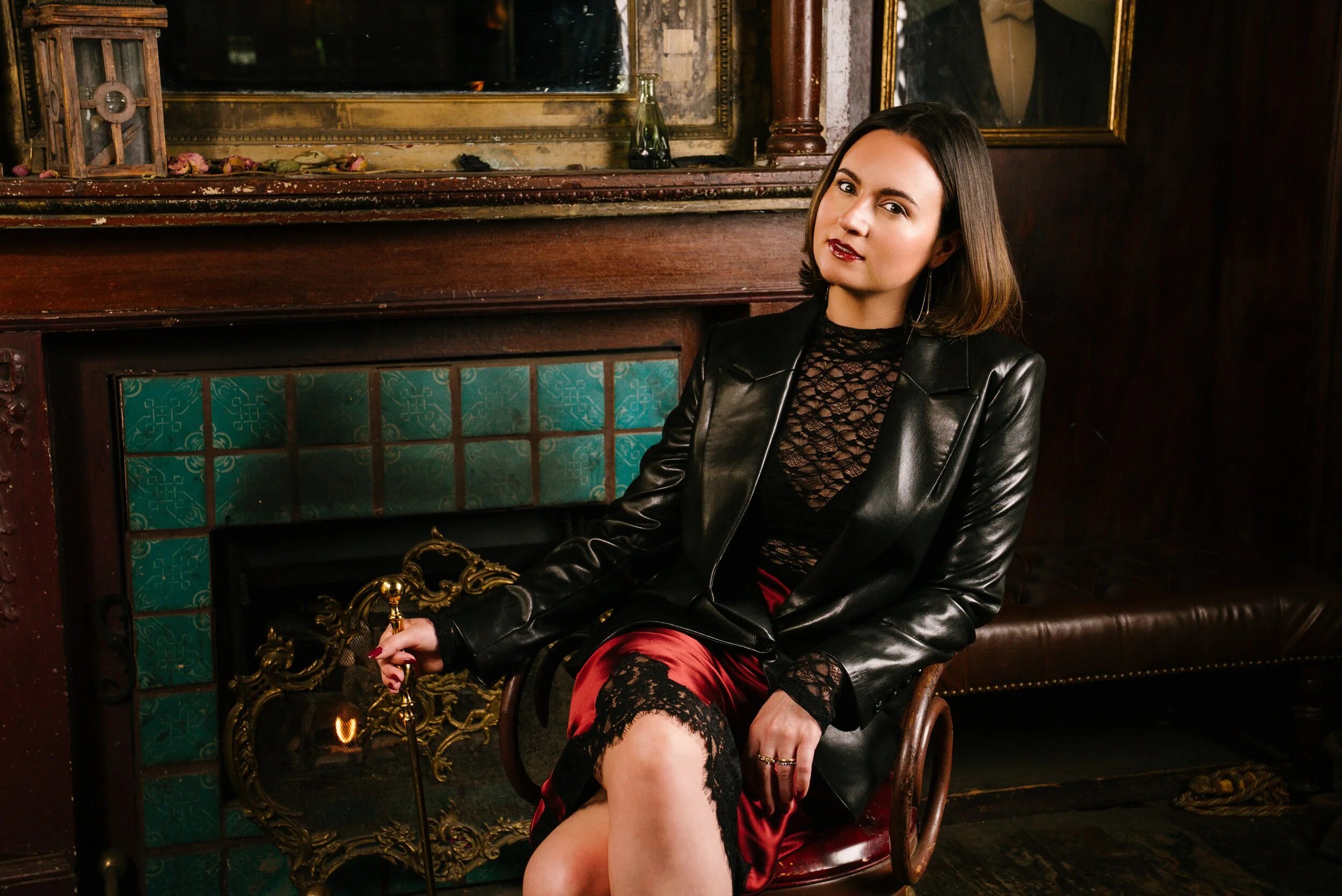 Heart Starts Pounding creator Kaelyn Moore seated beside an ornate fireplace in the show’s official portrait