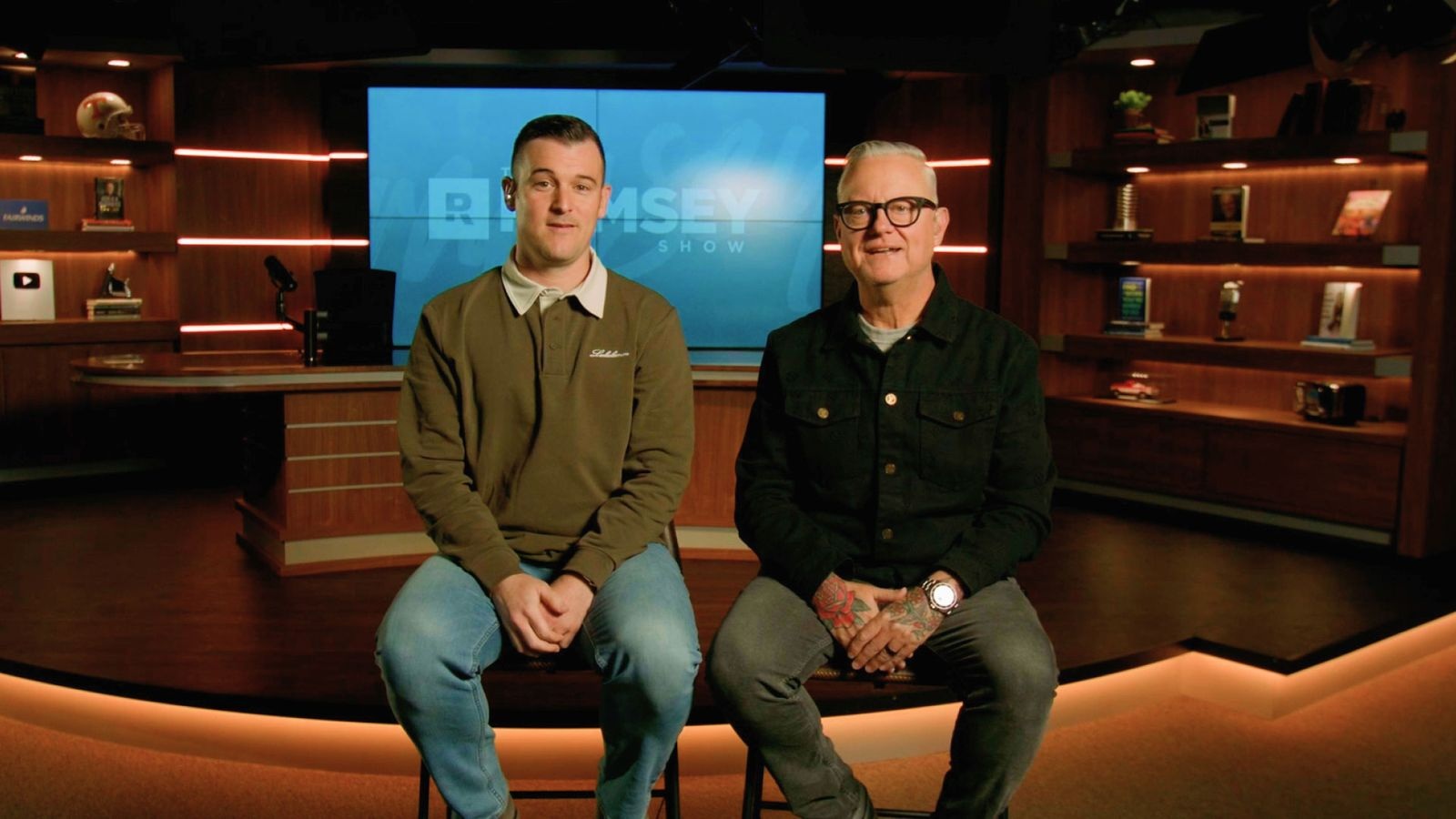 Ramsey Network executives Hank Fuerst and Blake Thompson seated in The Ramsey Show studio